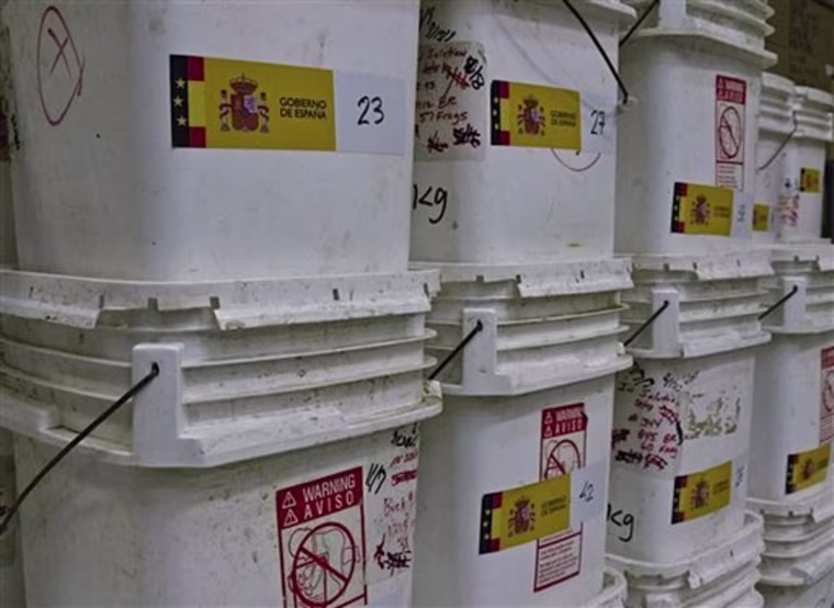 In this undated photo made available by the Spain's Culture Ministry,white plastic buckets containing the 594,000 coins and other artifacts found in the Nuestra Senora de las Mercedes, a Spanish galleon sunk by British warships in the Atlantic while sailing back from South America in 1804, in a warehouse in Tampa, Fla. A 17-ton trove of silver coins recovered from the Spanish galleon was set to be flown Friday Feb. 24, 2012 from the United States to Spain, concluding a nearly five-year legal struggle with Odyssey Marine Exploration, the Florida deep-sea explorers who found and recovered it. (AP Photo/Spain's Culture Ministry, HO)